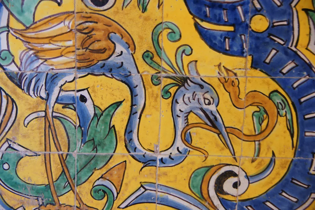 Eine bemalte Azulejo-Tafel mit einem langhalsigen Vogel in Gelb, Blau und Grün